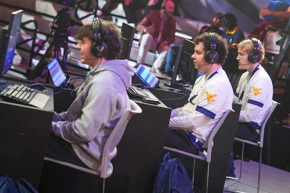 Youth participants working with a robotic arm on a table