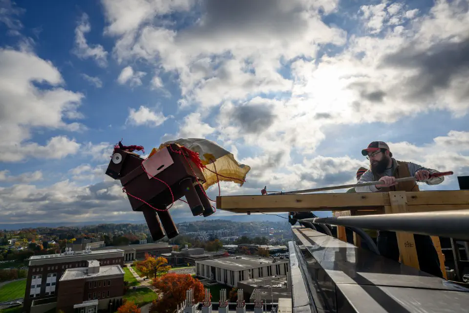 Youth participants working with a robotic arm on a table